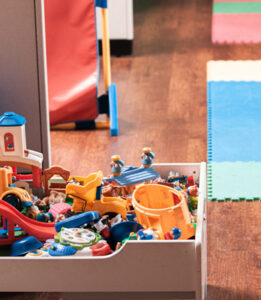 image of a messy toy box in kids room waiting to be decluttered