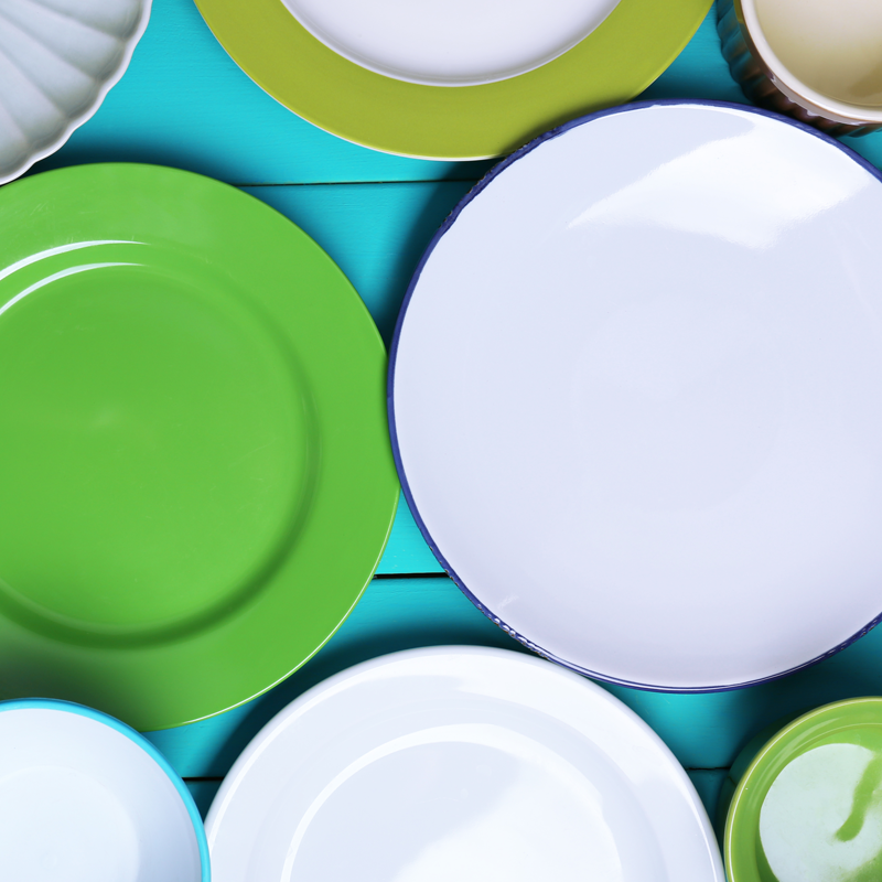 Photo of plates in a cluttered cupboard